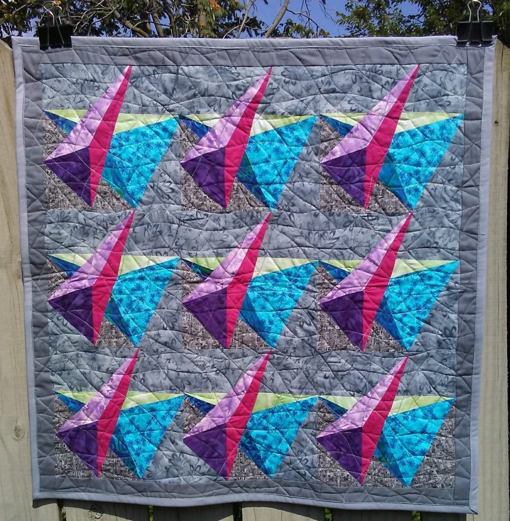 Superimposed pyramidal shapes on gray background.