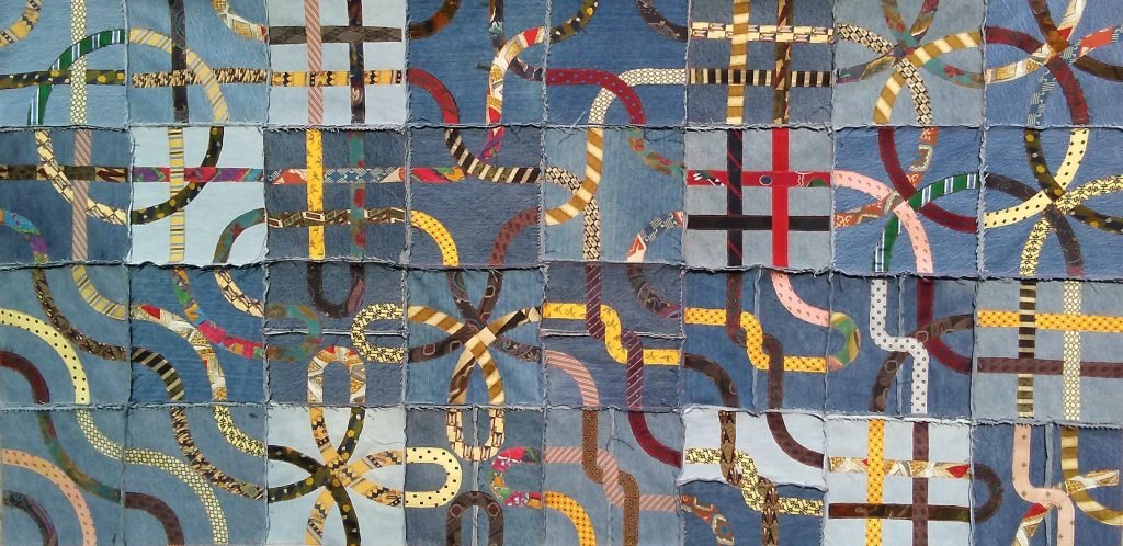 Silk knotwork on recycled denim.