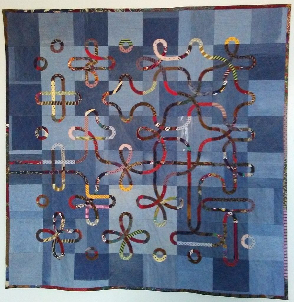 Silk knotwork on recycled denim.