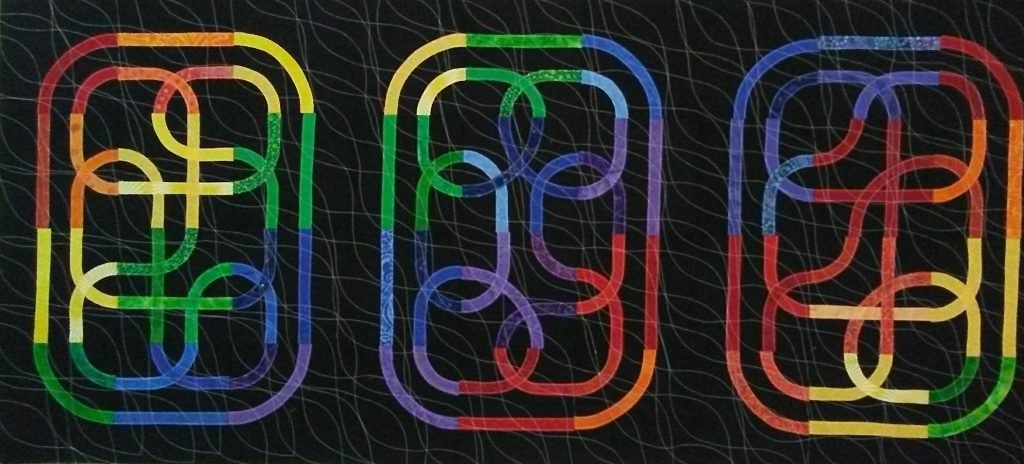 Three multi-colored knots on black background.