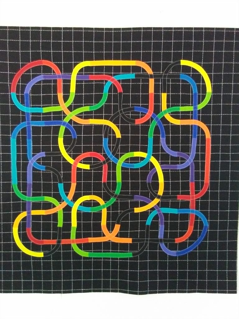 Multi-colored knotwork on black background.