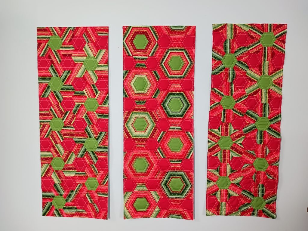 Three table runners using striped hexagons.