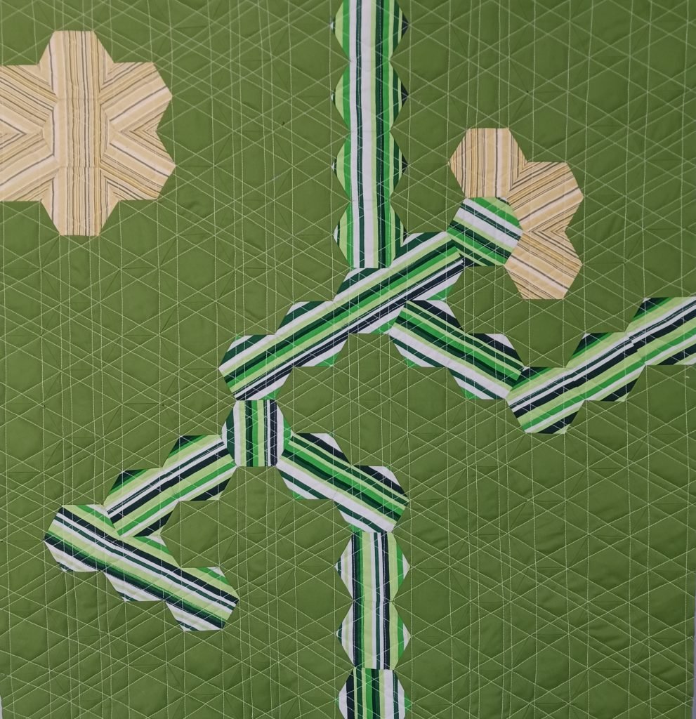 Striped hexagons make stick figure on green background.