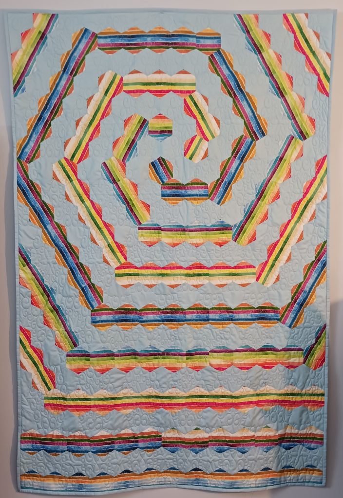 Striped hexagons form 3-arm spiral.