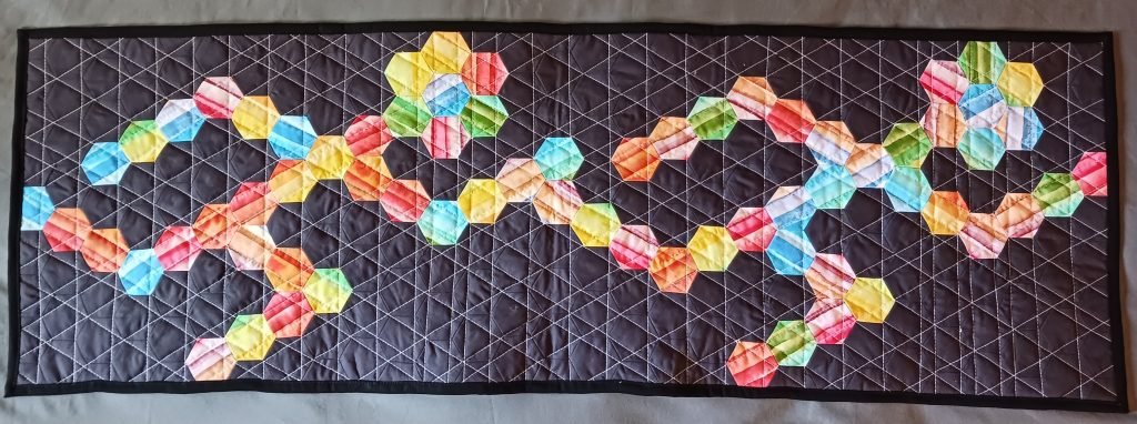 Striped hexagons form two running figures on black background