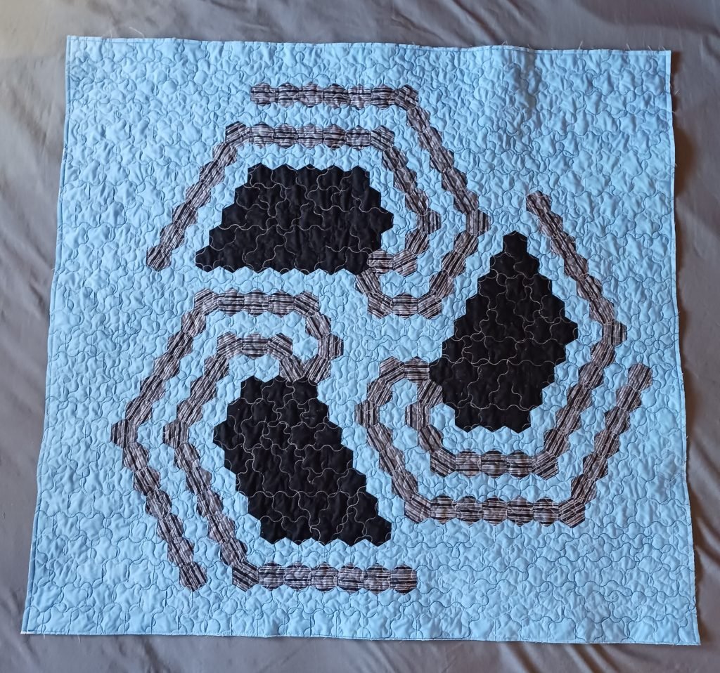 Gray hexagonal spiral on light blue background.