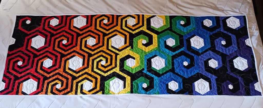 Spirals change color across the quilt