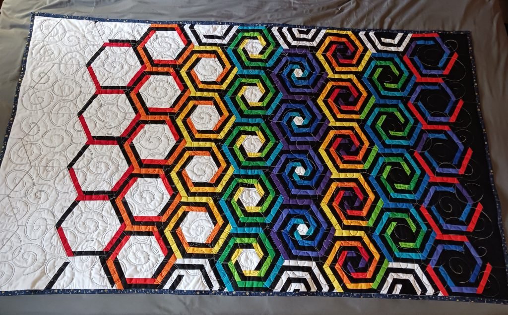 Spirals fill in across the face of the quilt.