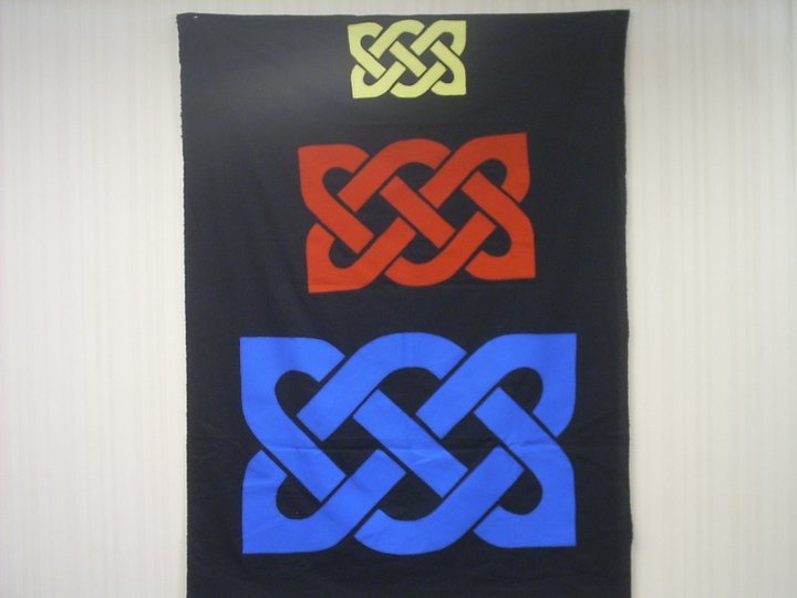 Yellow, red, and blue Celtic knots in three different sizes.